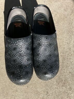 Dansko Black Floral Embossed Clogs